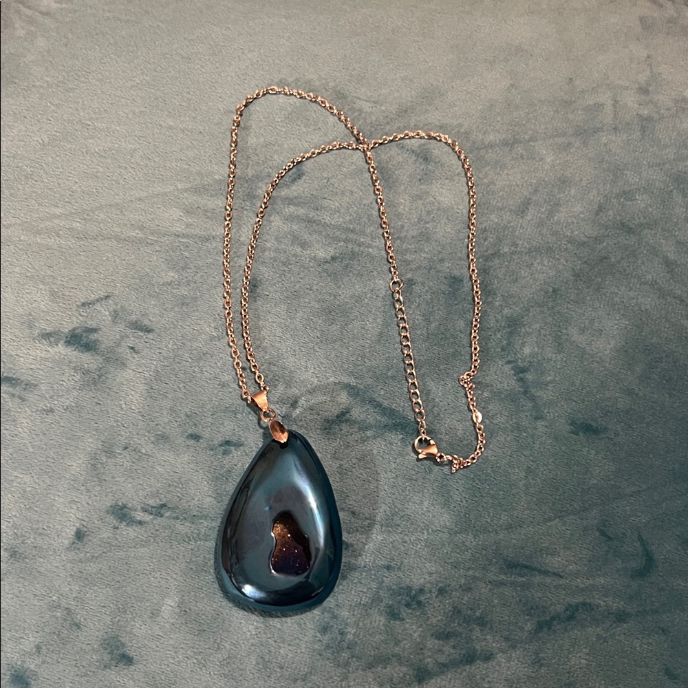 Blue stone pendant on silver chain